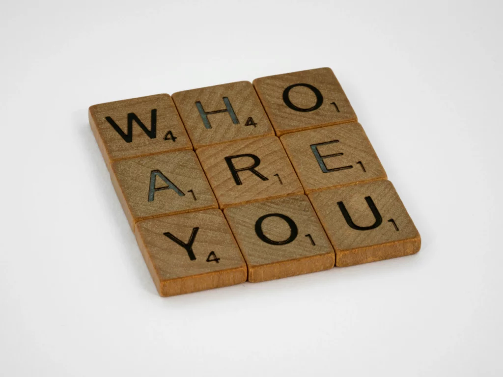 Wooden letters spelling out the words ‘WHO ARE YOU’, a symbolic reference to the use of tools such as the Gallup talents and personality tests